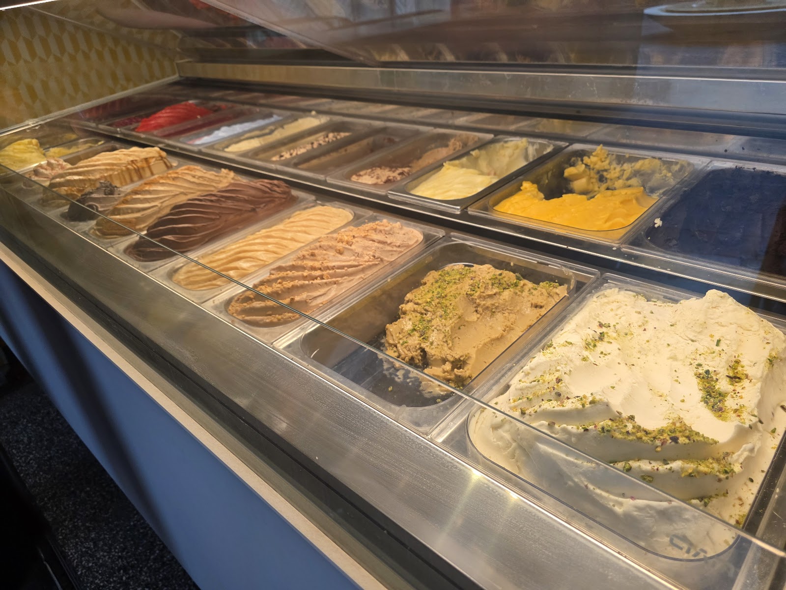 Trays of Arabic ice cream behind the counter glass
