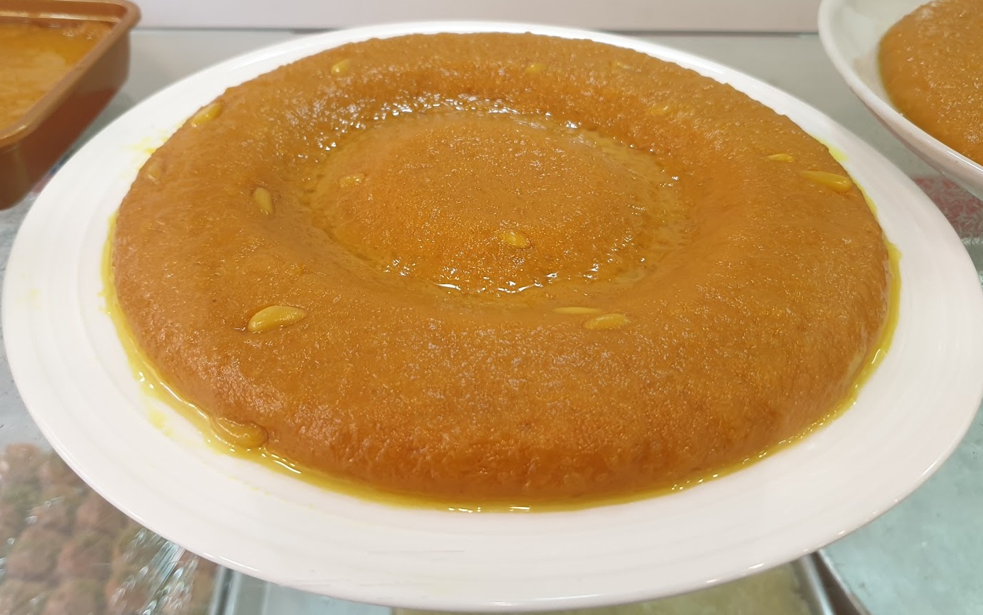 A syrup-glossed sweet round on a white plate