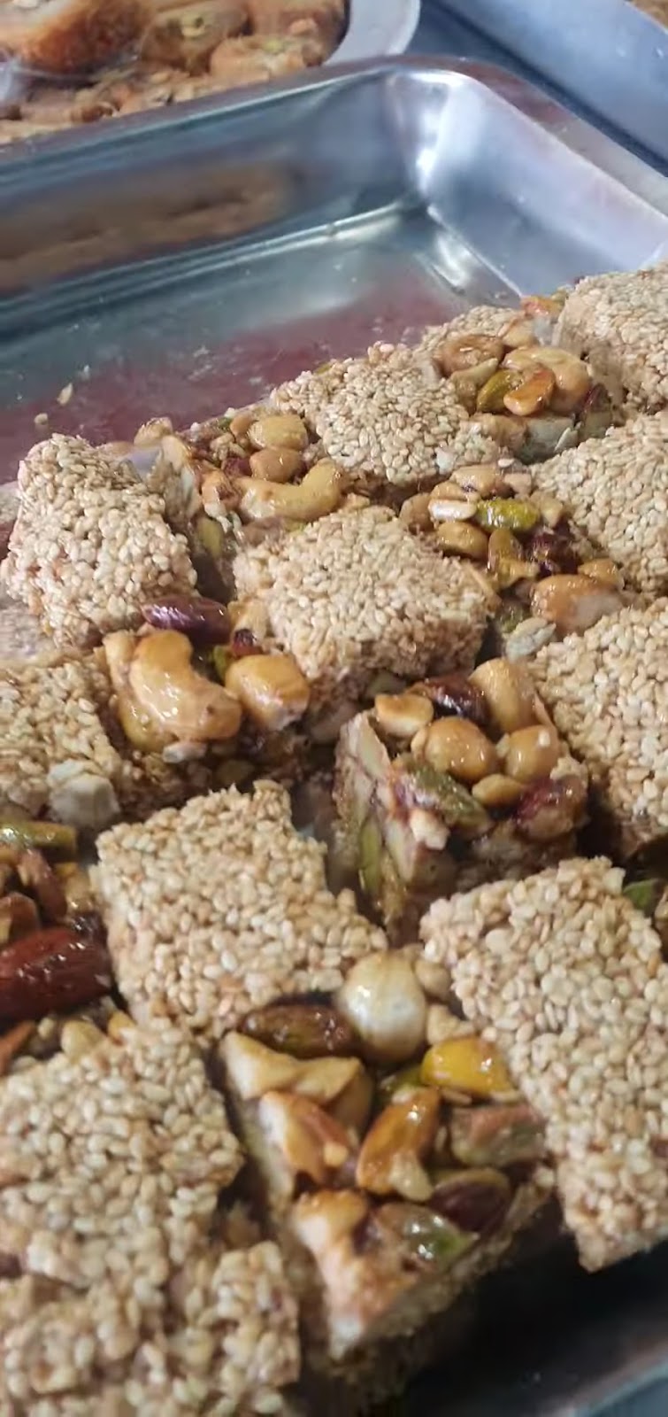 Sesame and nut bars cut square on a tray
