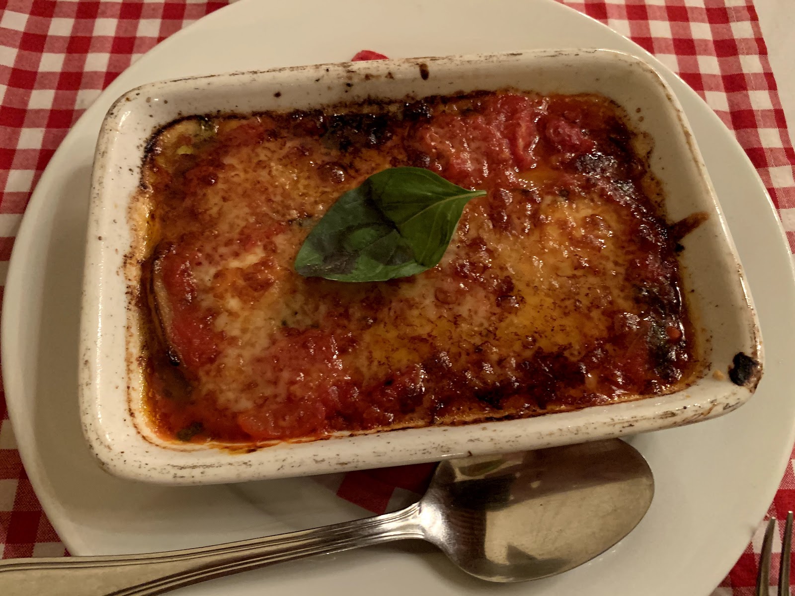 The house lasagne in its dish on the red checked cloth at Appetito