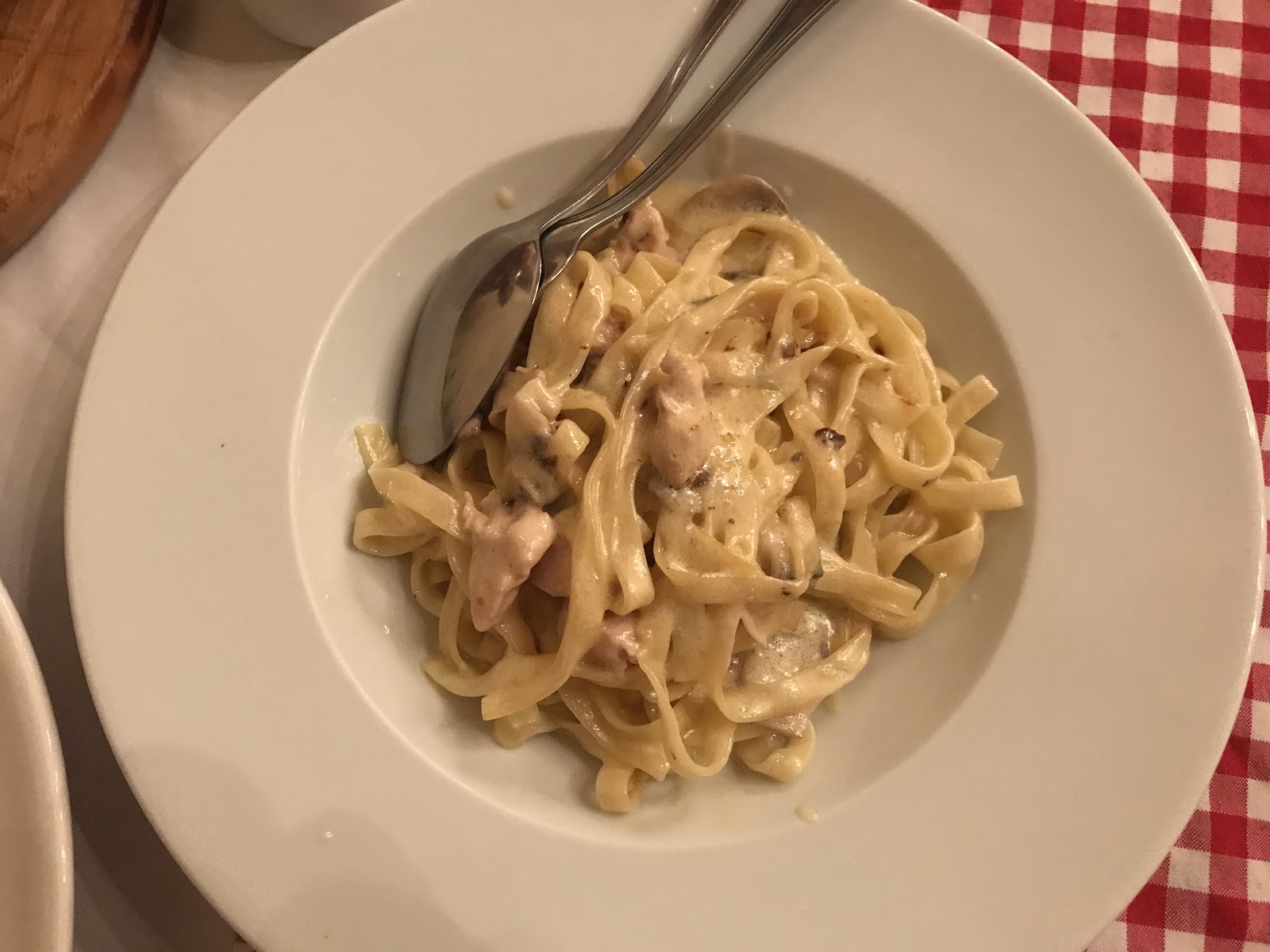 Tagliatelle in a cream sauce on a white plate