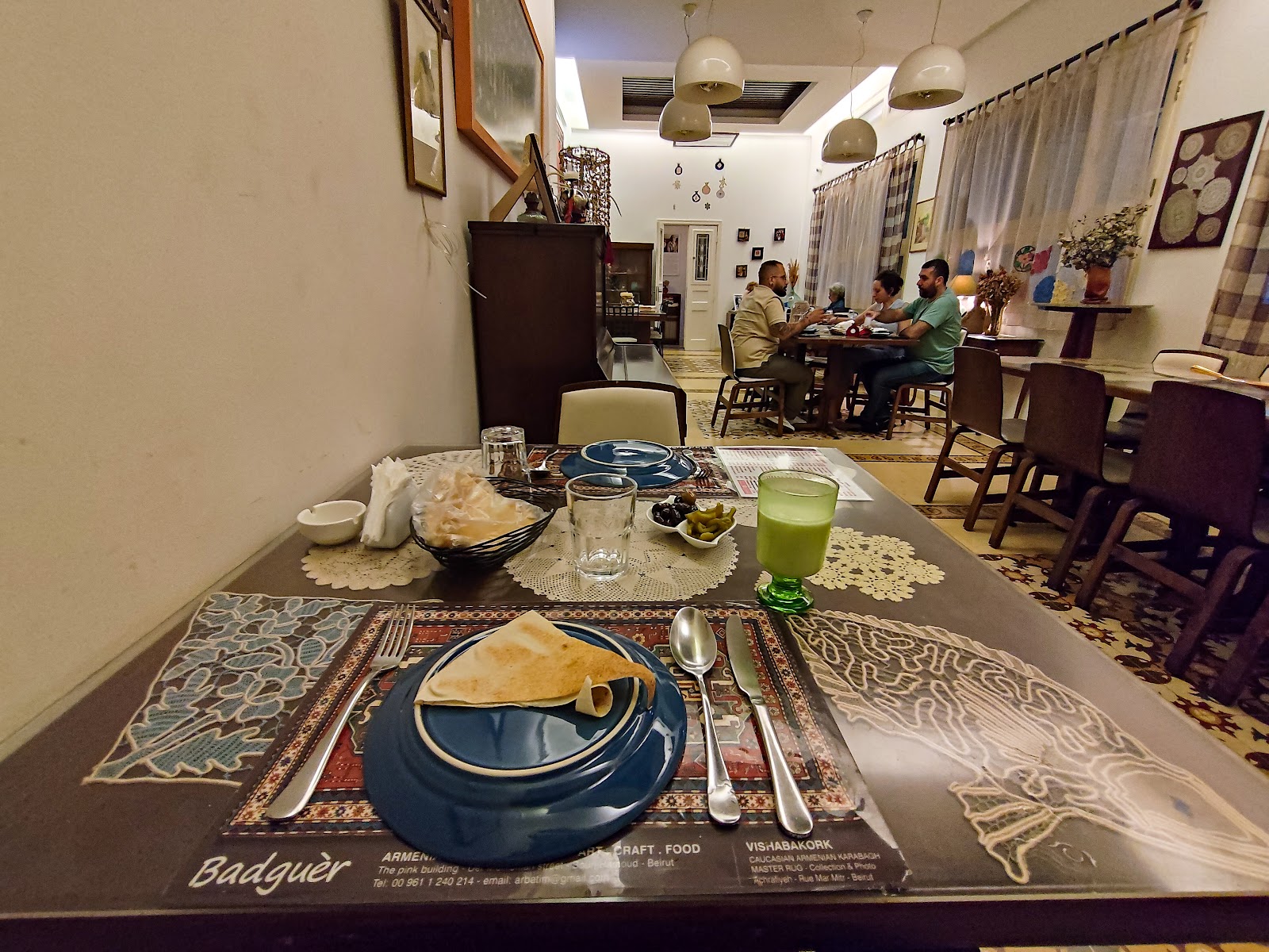 The dining room set with Badguer placemats, saj bread and blue plates
