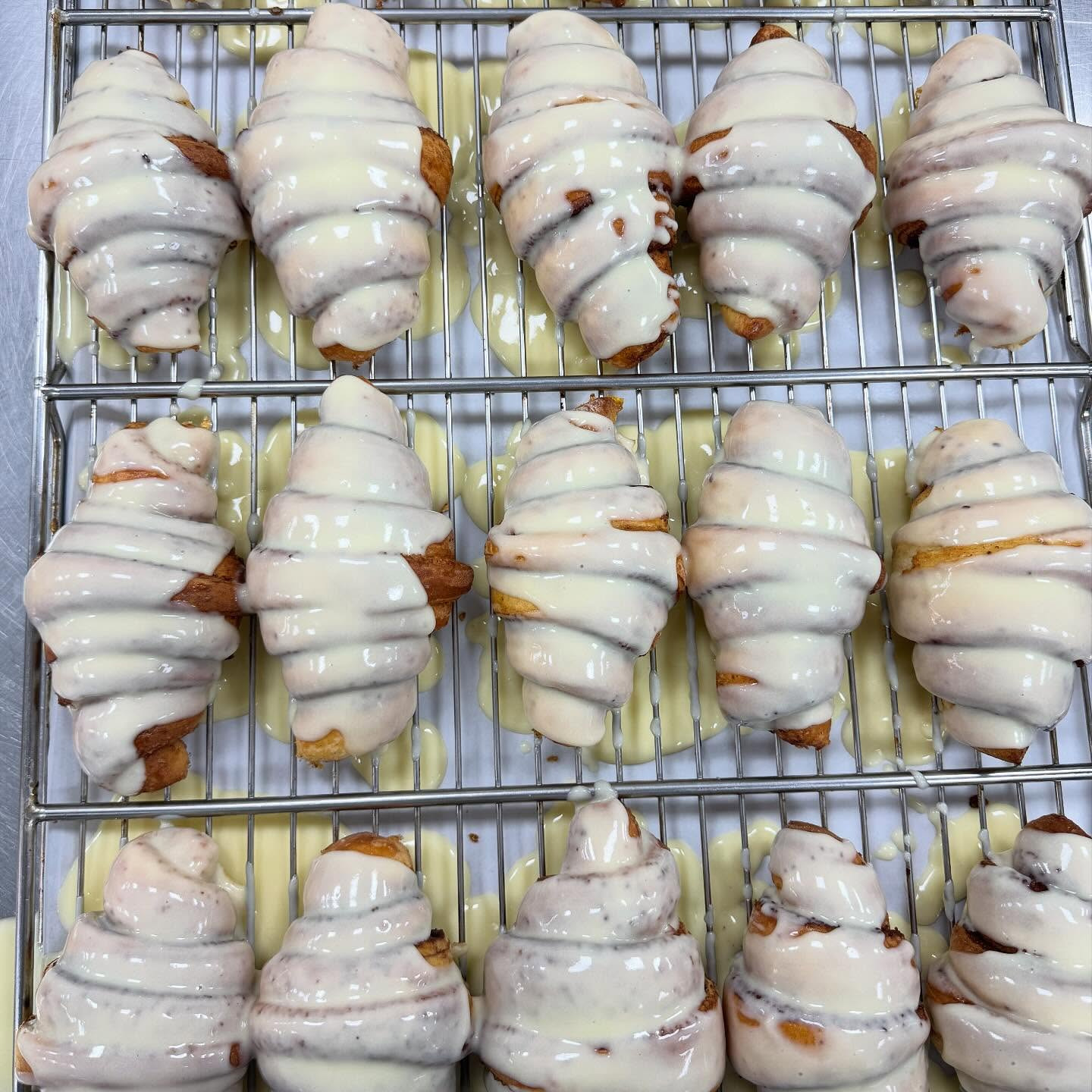 Glazed pastries cooling on wire racks in the kitchen