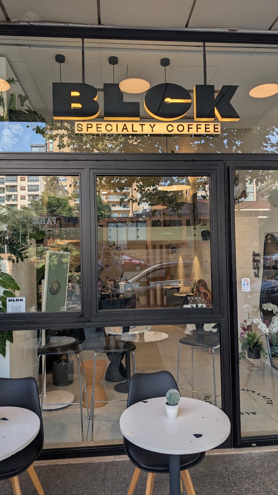 The BLCK storefront with its black and gold sign and window counter