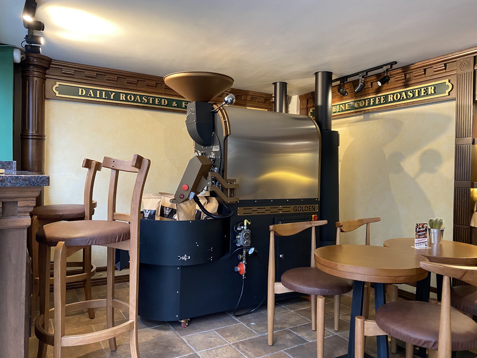 The roasting machine and wooden bar inside Caffeine Coffee Beirut