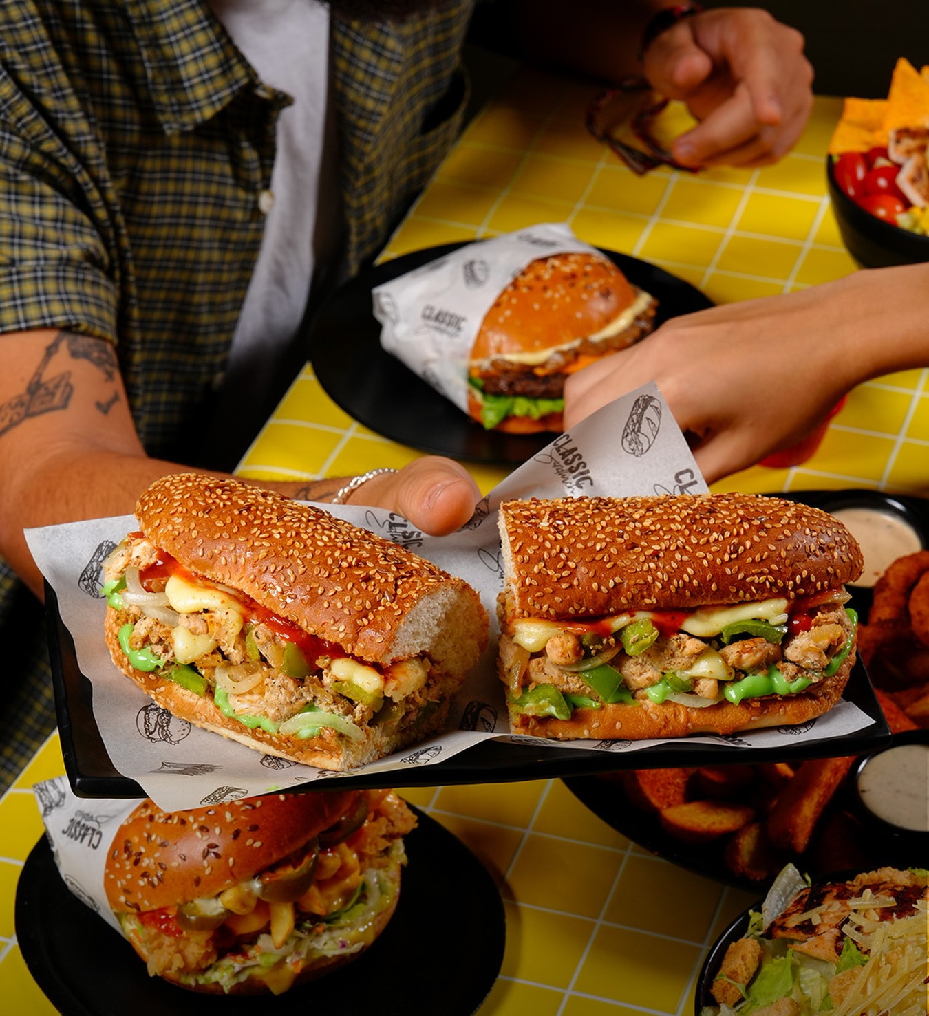 Two long sandwiches opened to show the chicken and pepper filling