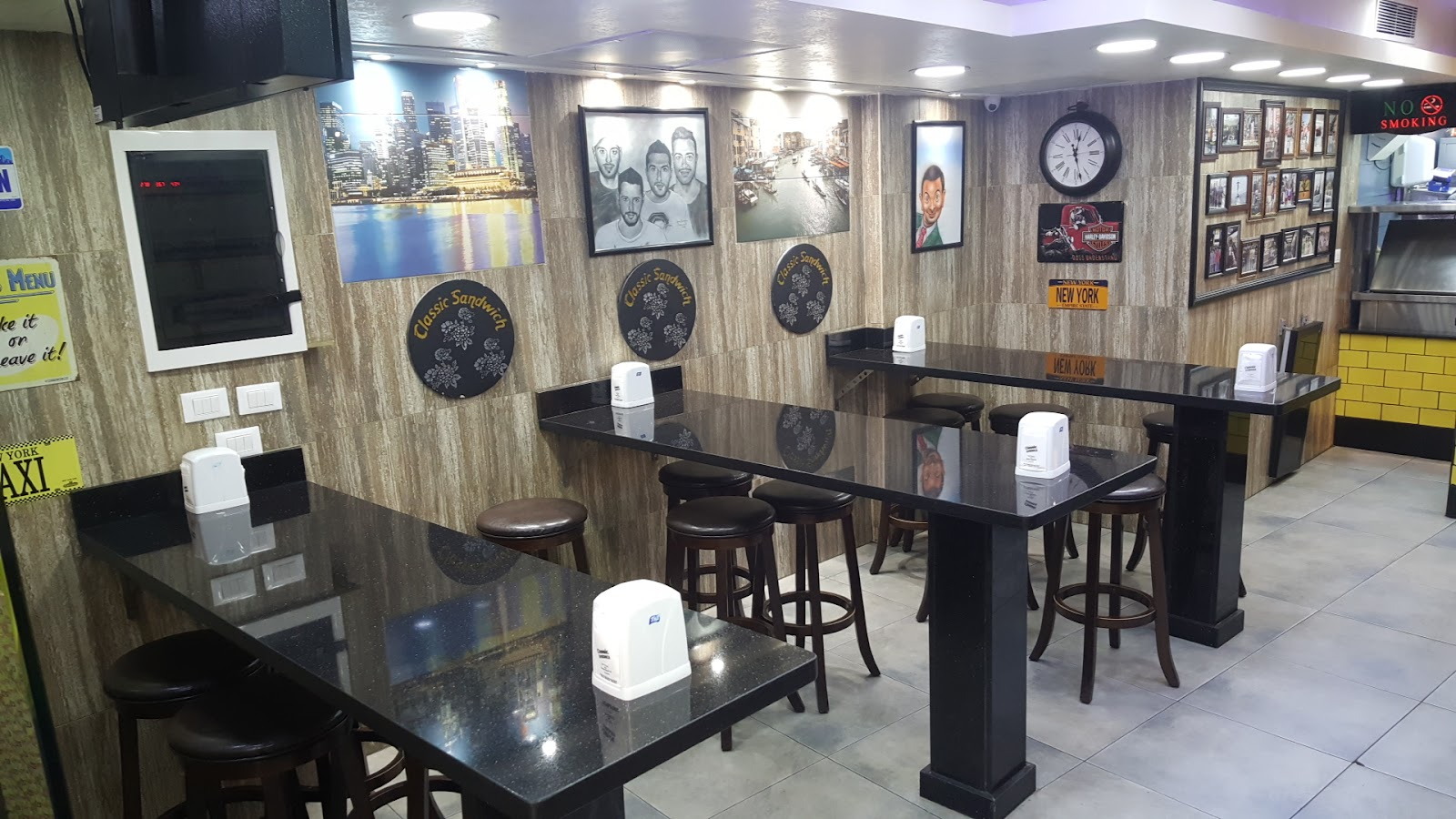 The dining room with dark tables and framed pictures