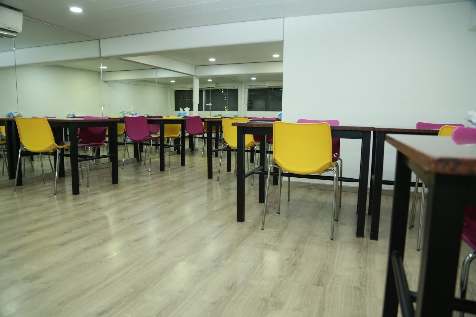 The bright dining room with colourful chairs