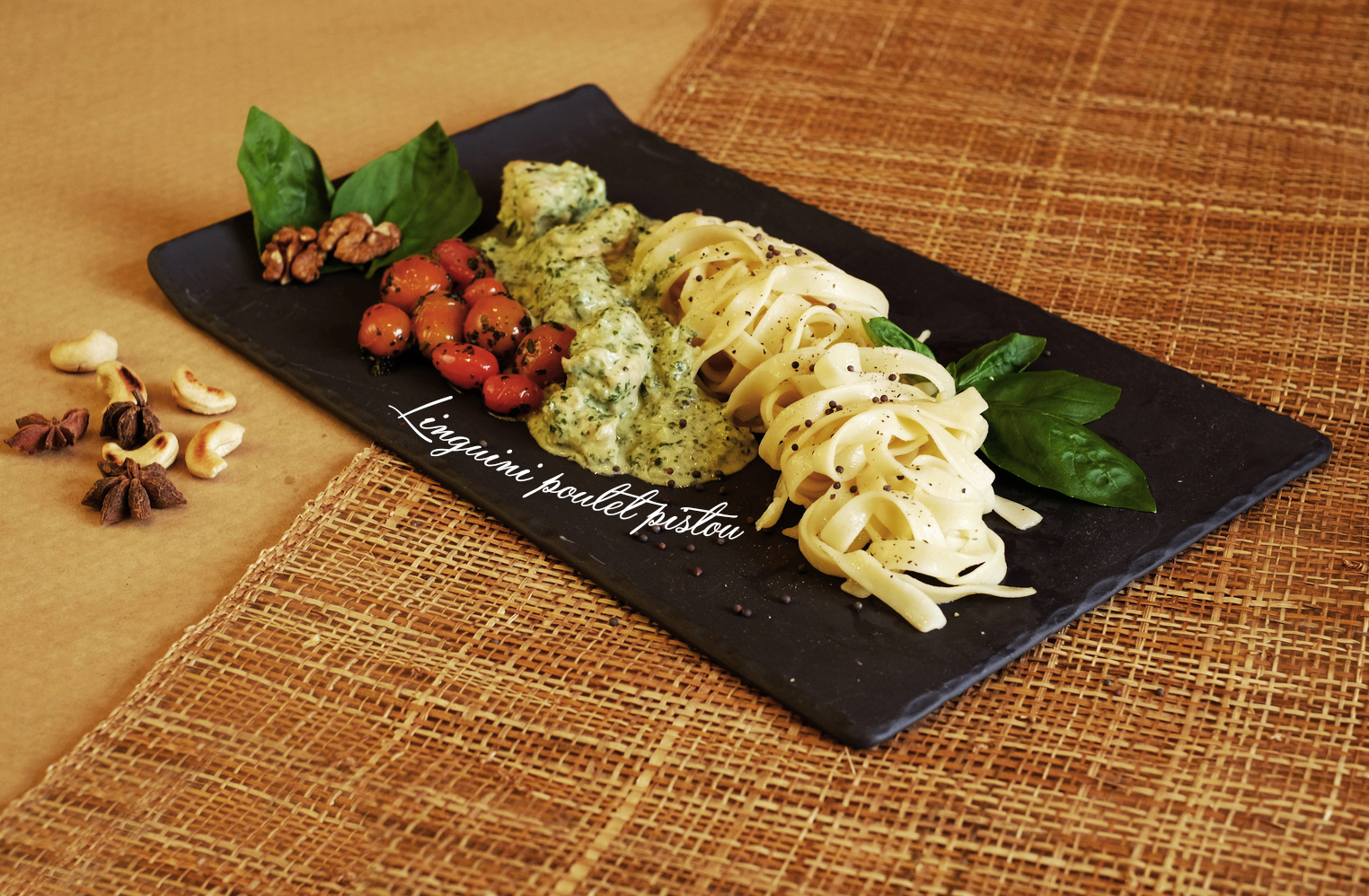 Seared fish plated long on a dark slate board
