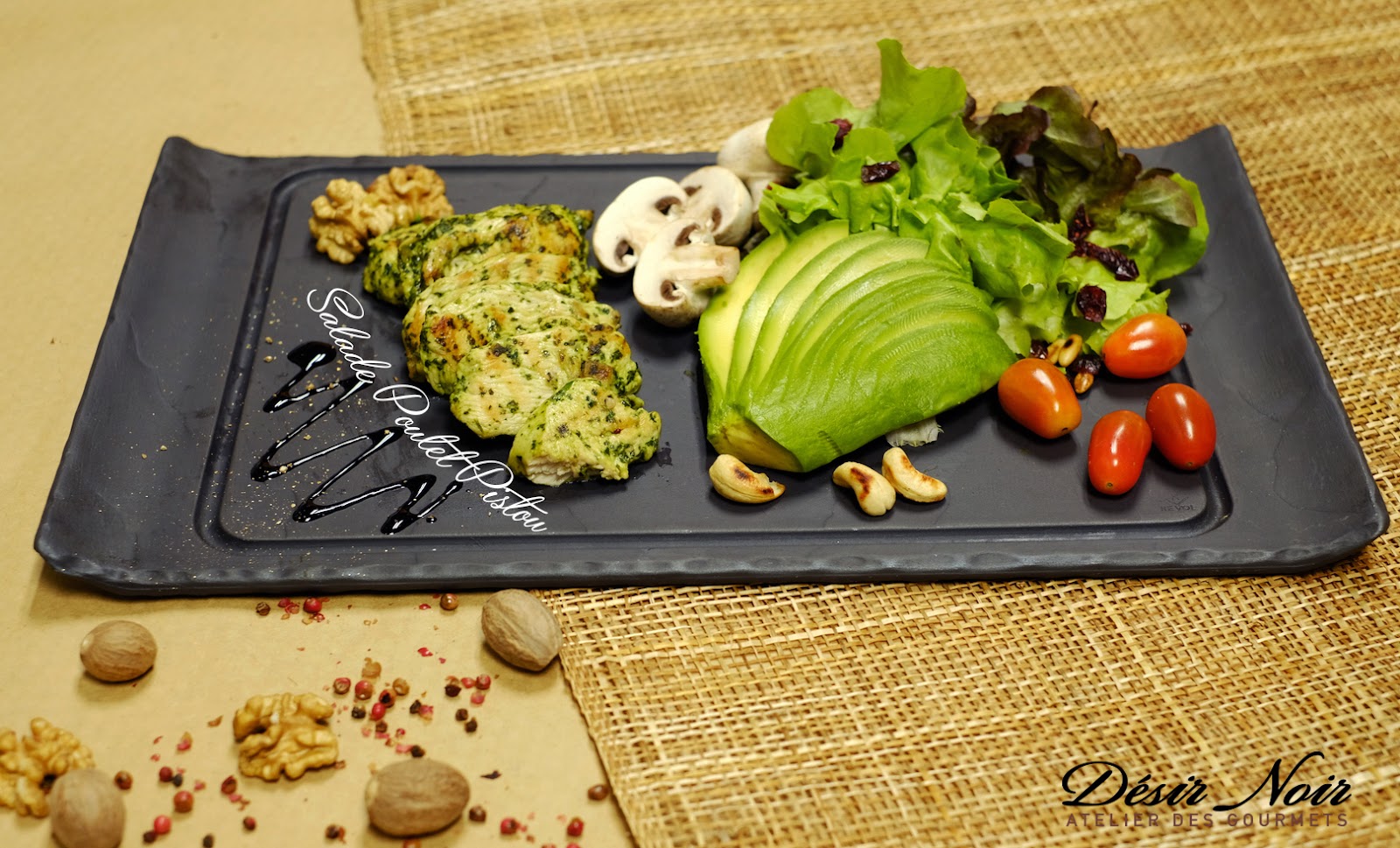A plated dish on the slate board with the house script beside it