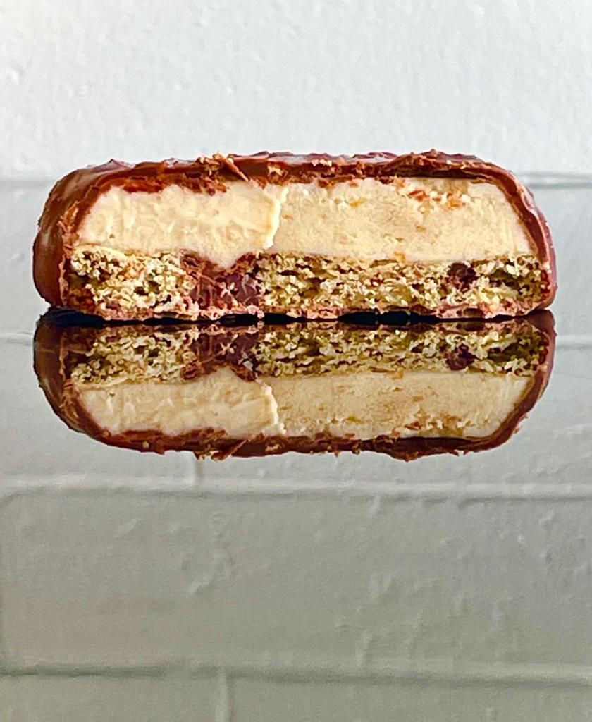 A chocolate-coated ice cream sandwich cut in half