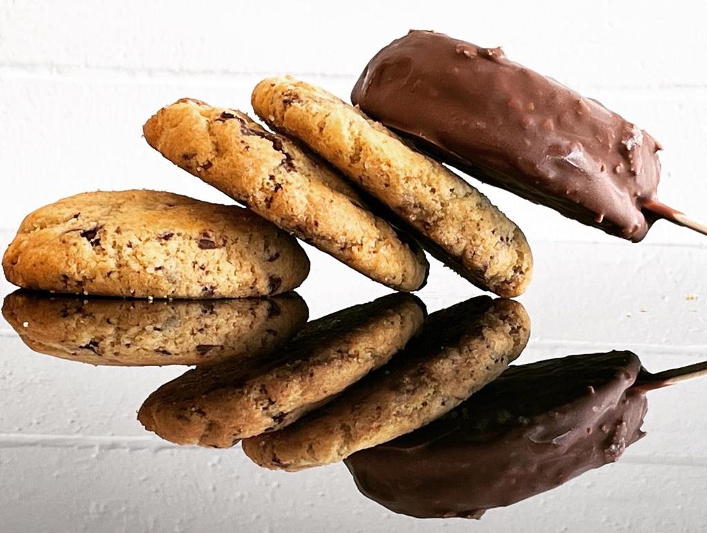 Cookies and chocolate-dipped bars arranged on a mirror