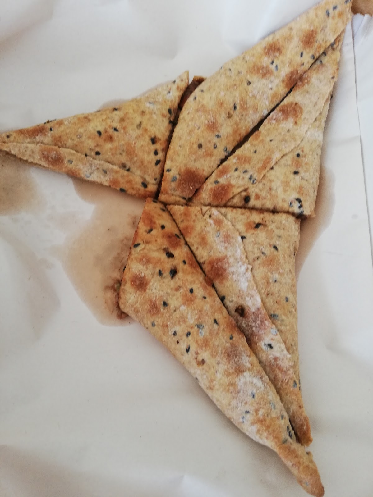A folded triangle manoushe on paper