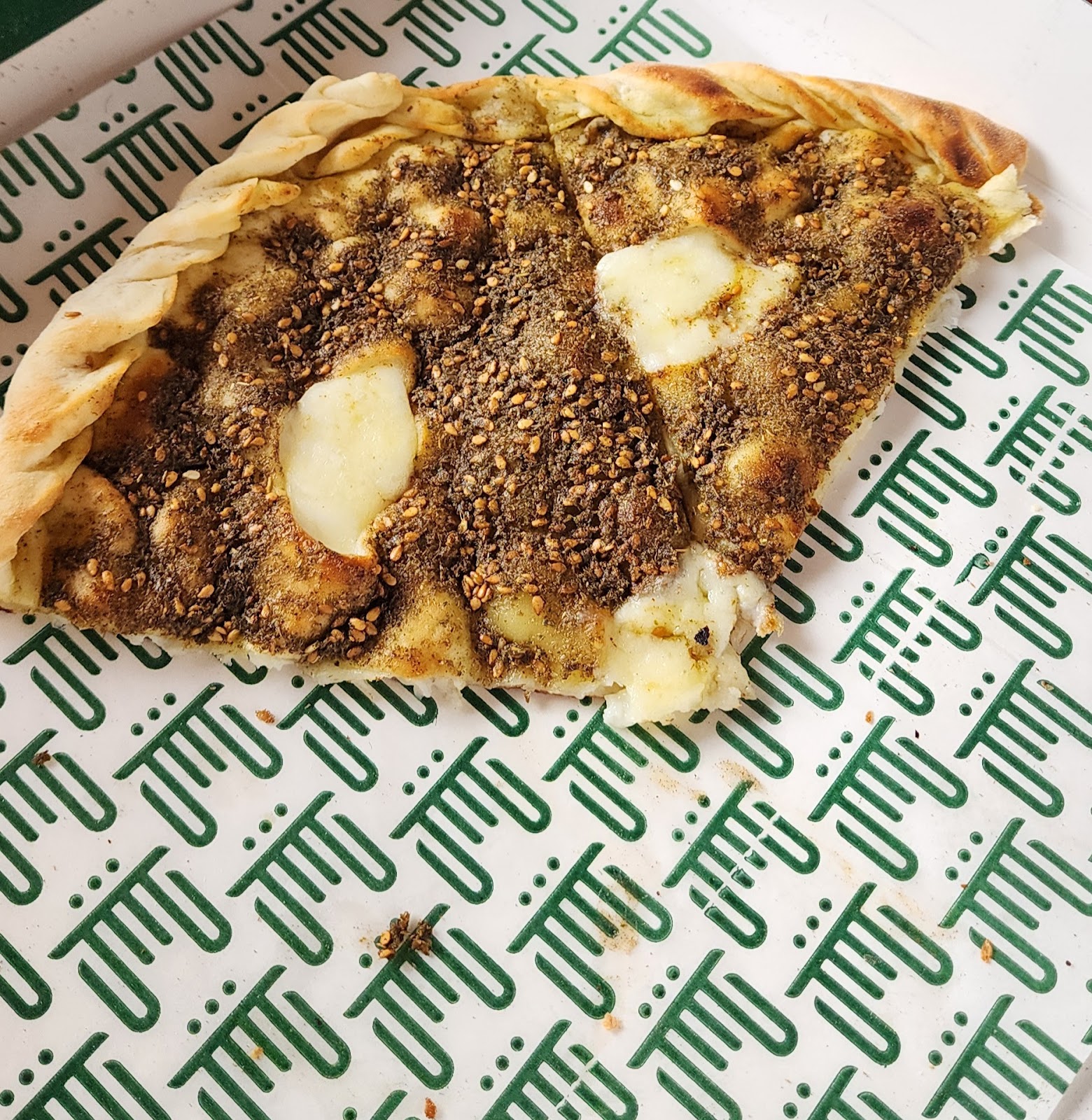 The duplex manoushe on the bakery's own printed green paper