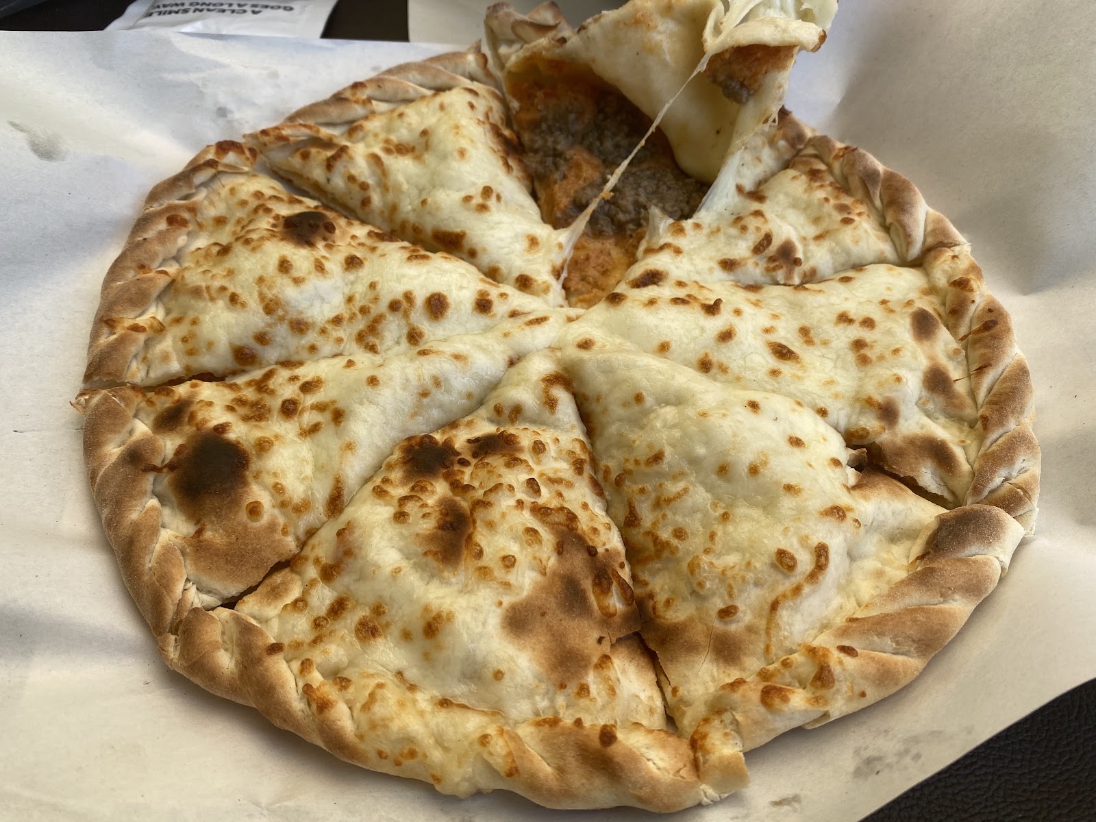 A round cheese manoushe with a browned crust