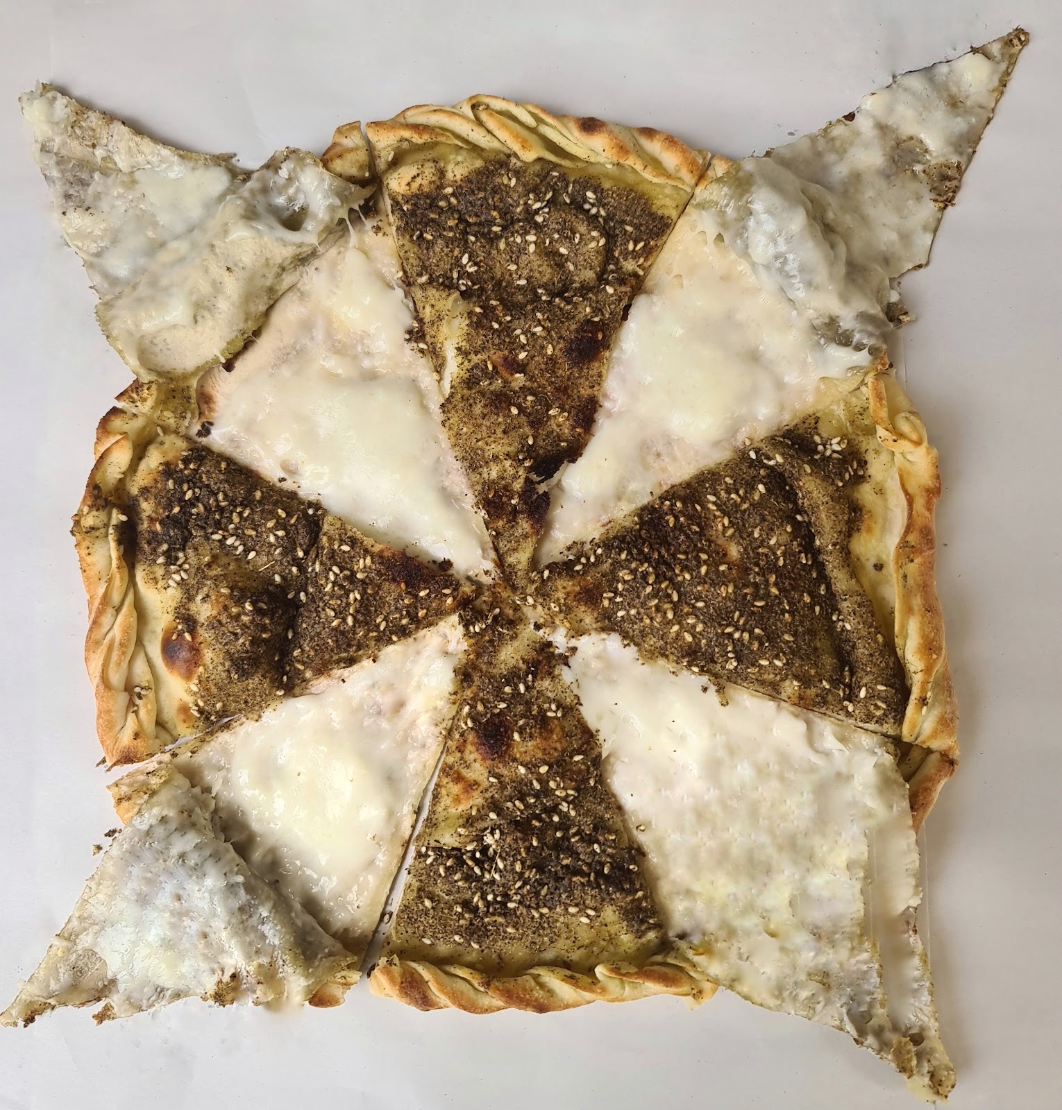 The duplex manoushe cut in a star, half zaatar and half cheese