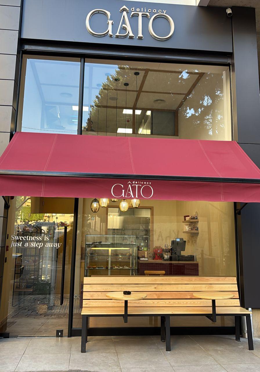 The Gato Delicacy shopfront with its dark facade and red awning