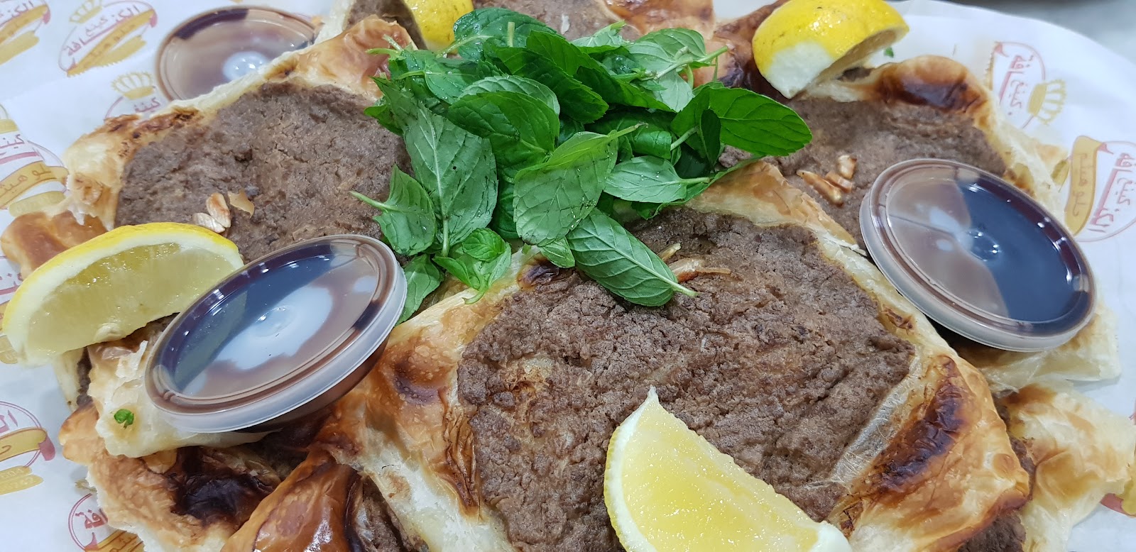 Ka'akeh knafeh plate with mint and lemon on the shop's own paper
