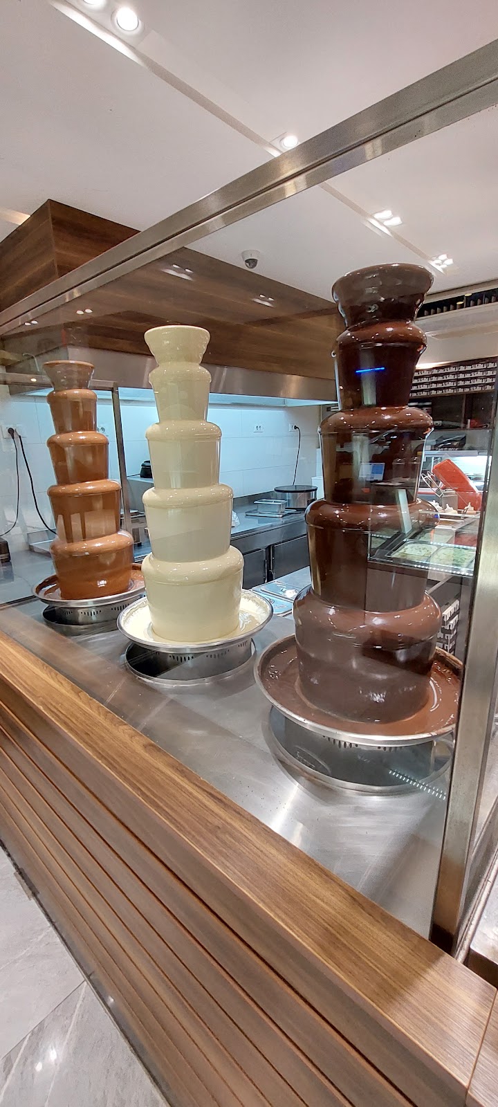 Chocolate fountains running behind the glass