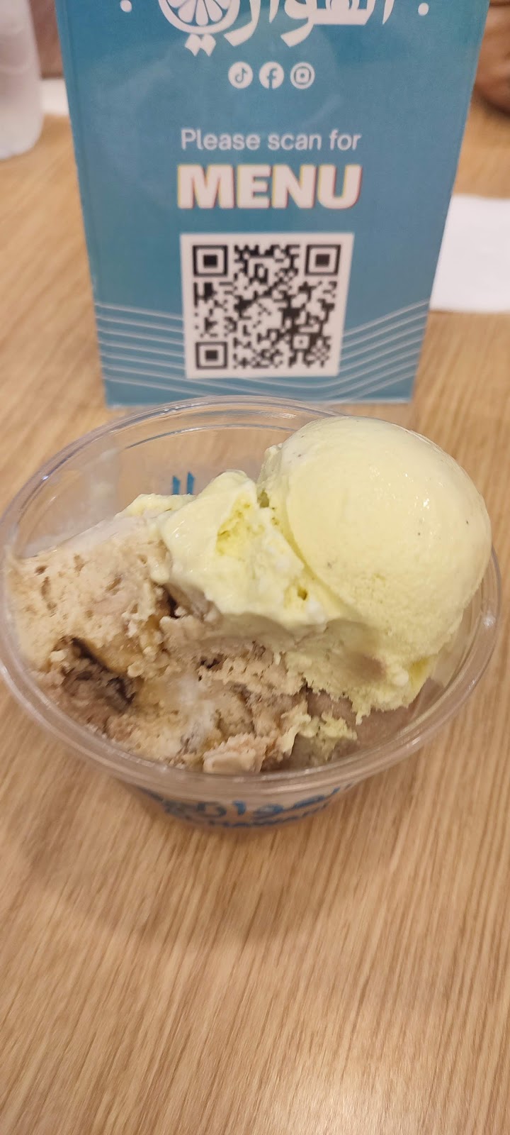 A cup of ice cream with biscuit pieces at the counter