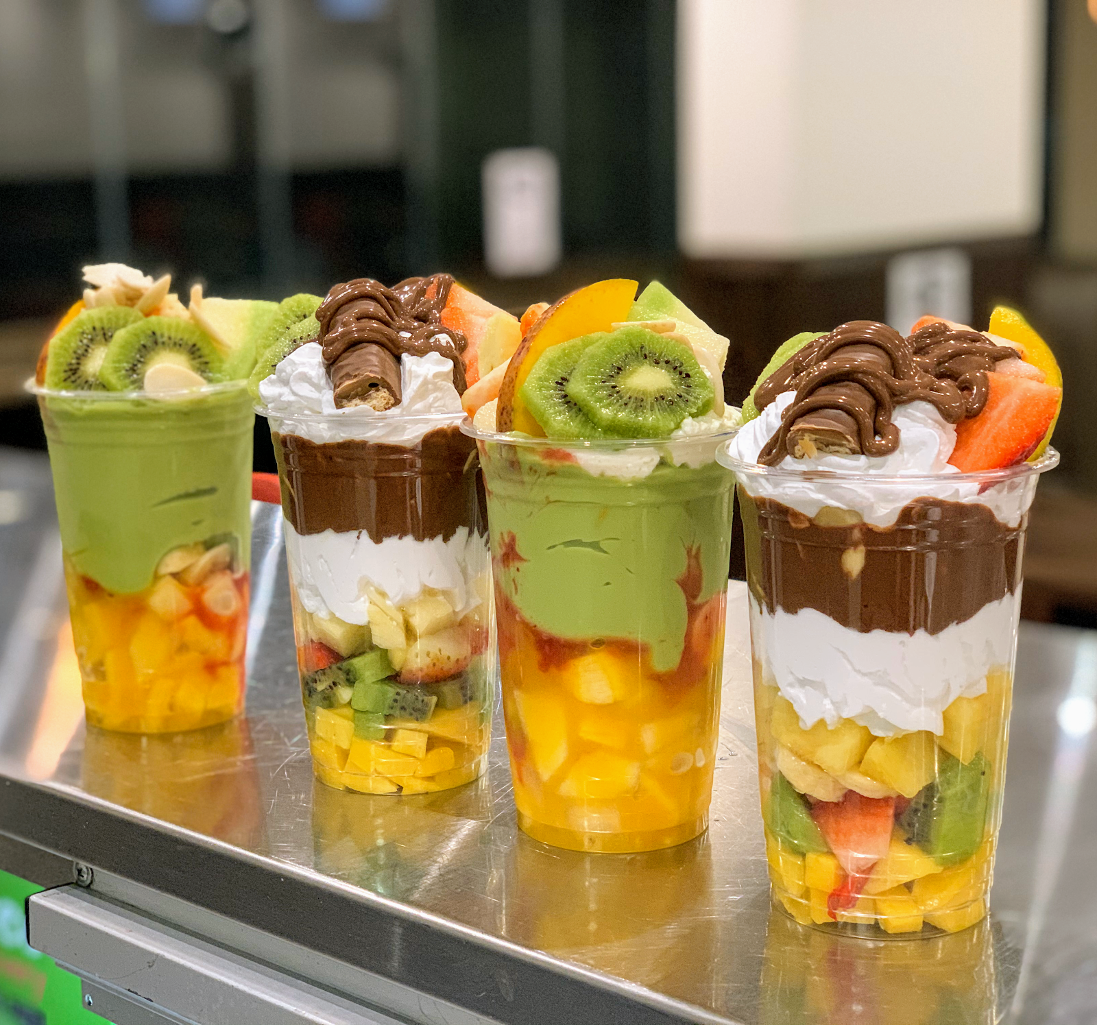 Layered fruit cocktail cups lined up on the counter
