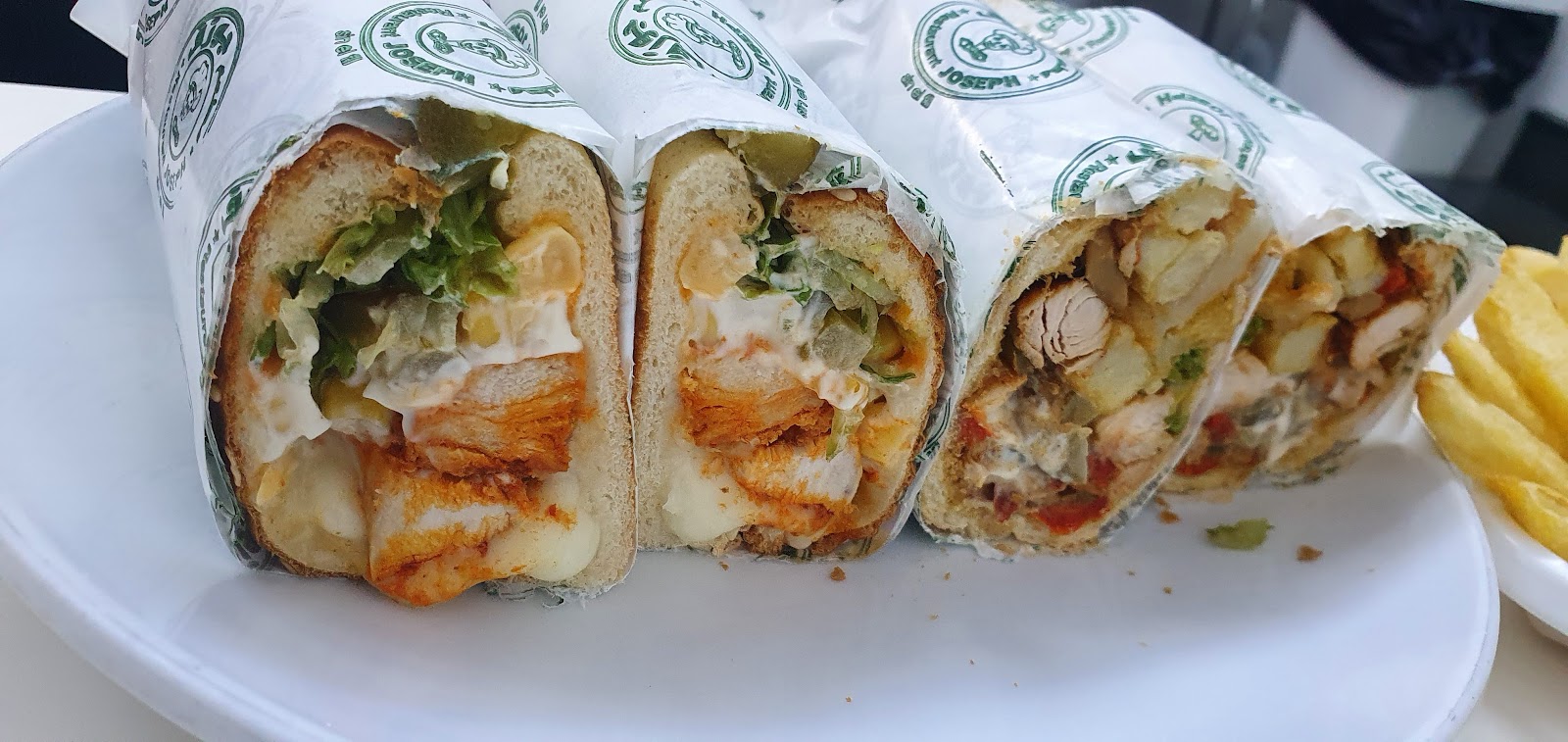 Wrapped sandwiches cut and arranged on a plate