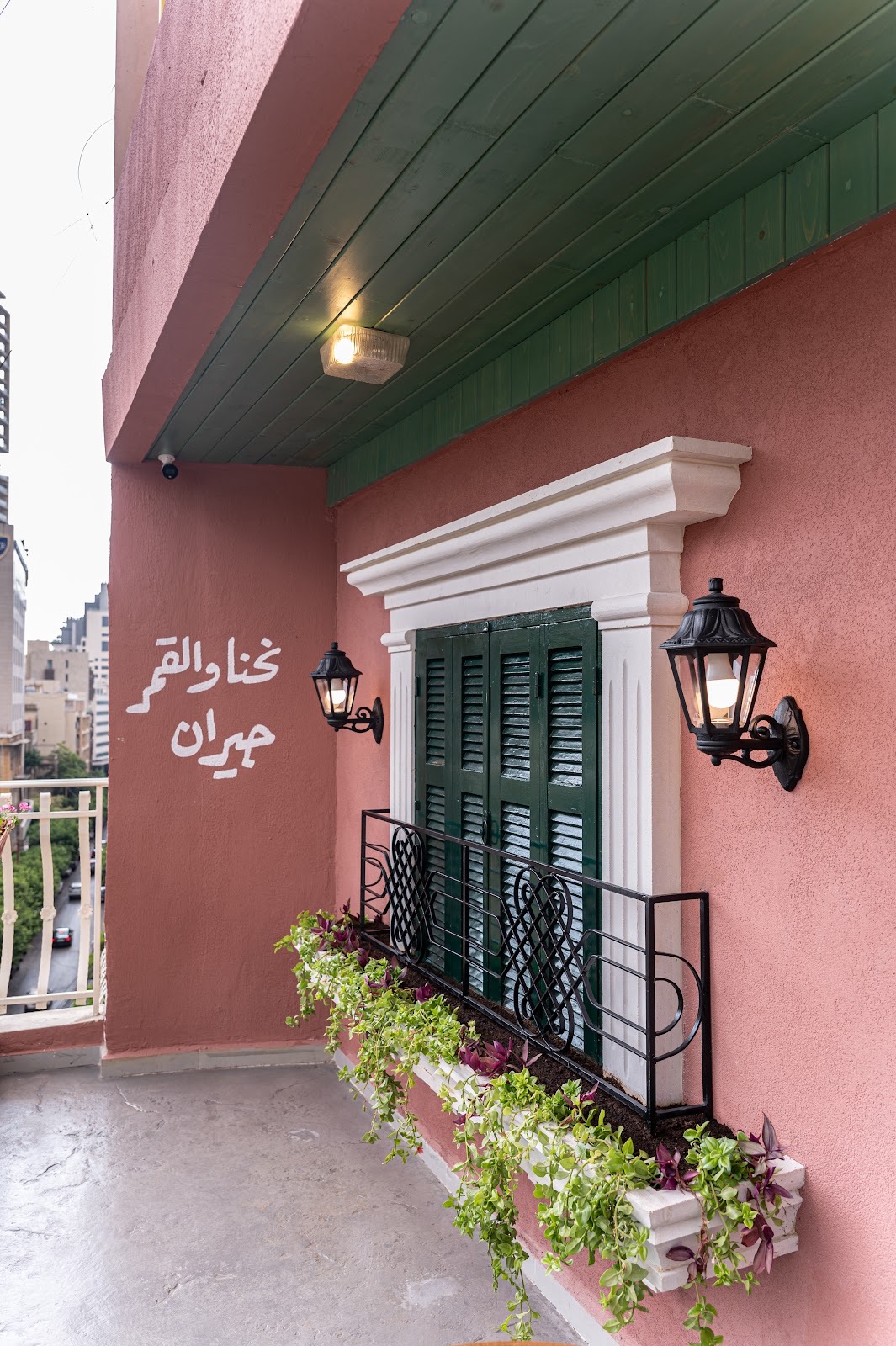 Kahwet 60 — pink wall and green shutters
