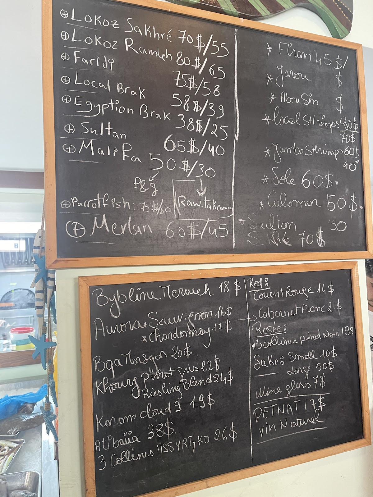 Kelly's Fish Lounge chalkboard — fish and wine
