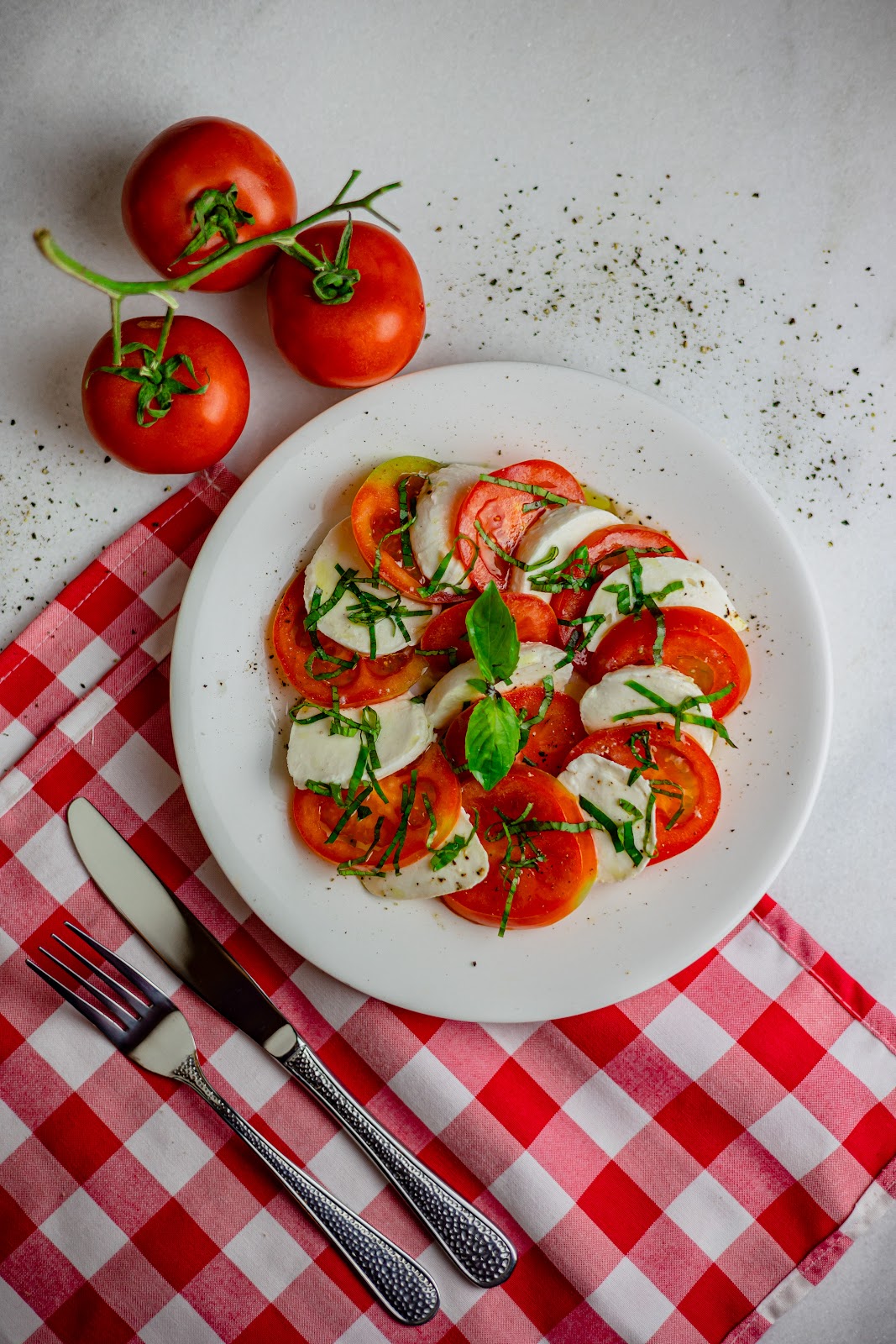 Caprese with tomatoes and mozzarella on a checked cloth