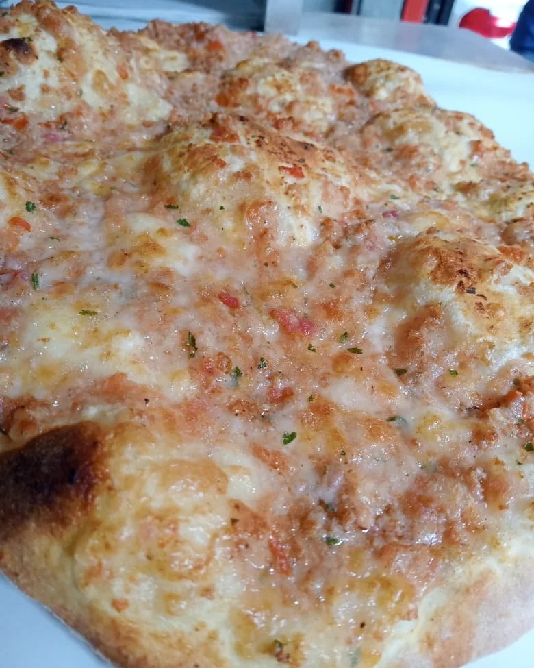 A cheese manoushe blistered gold across the top