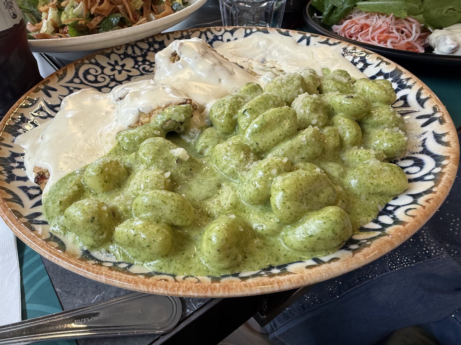 A plate of green pesto gnocchi