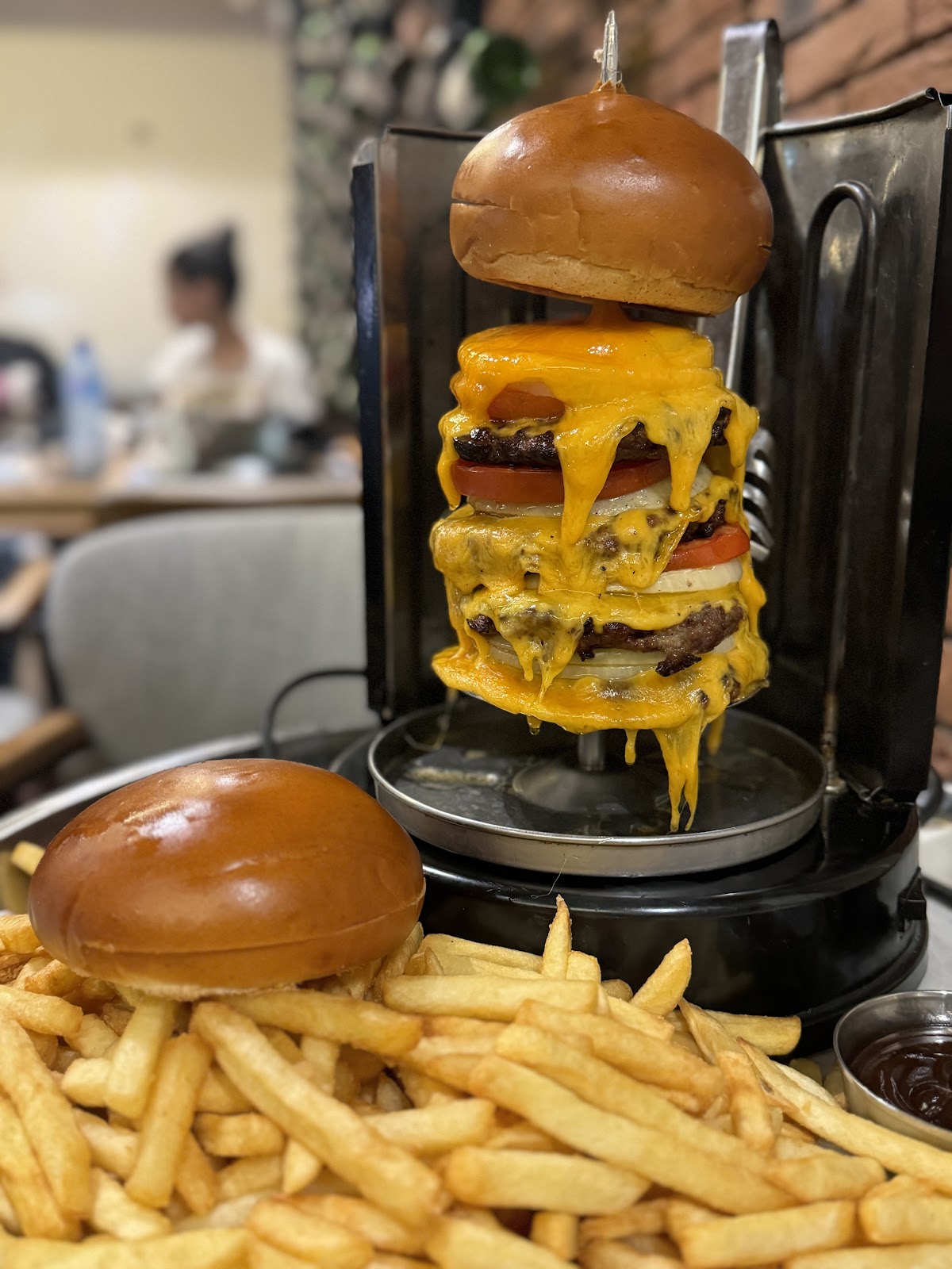 The stacked burger tower dripping cheese on its spike