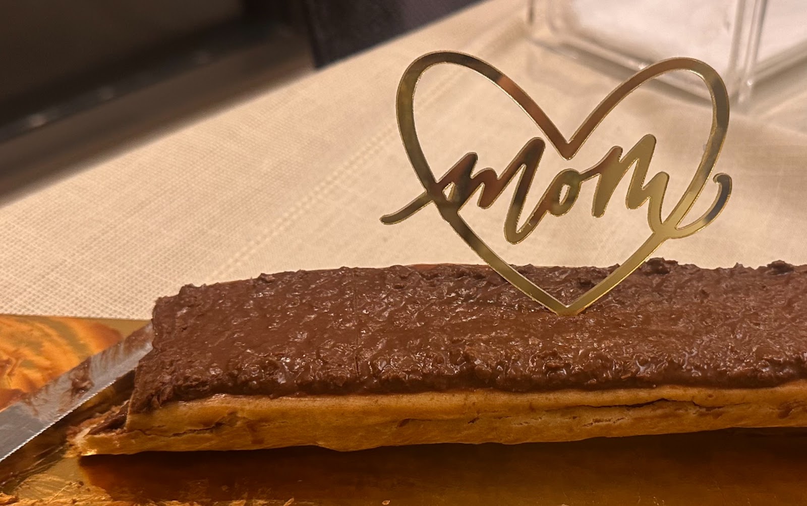 A chocolate log with a gold topper from the shop