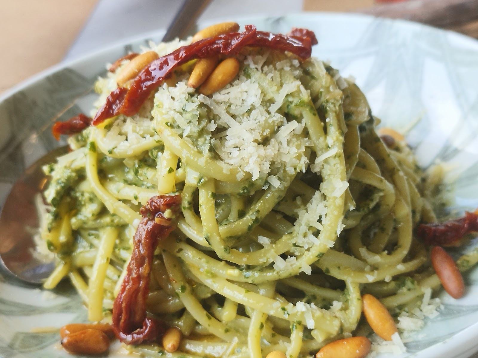Pesto pasta close up with pine nuts and dried tomato