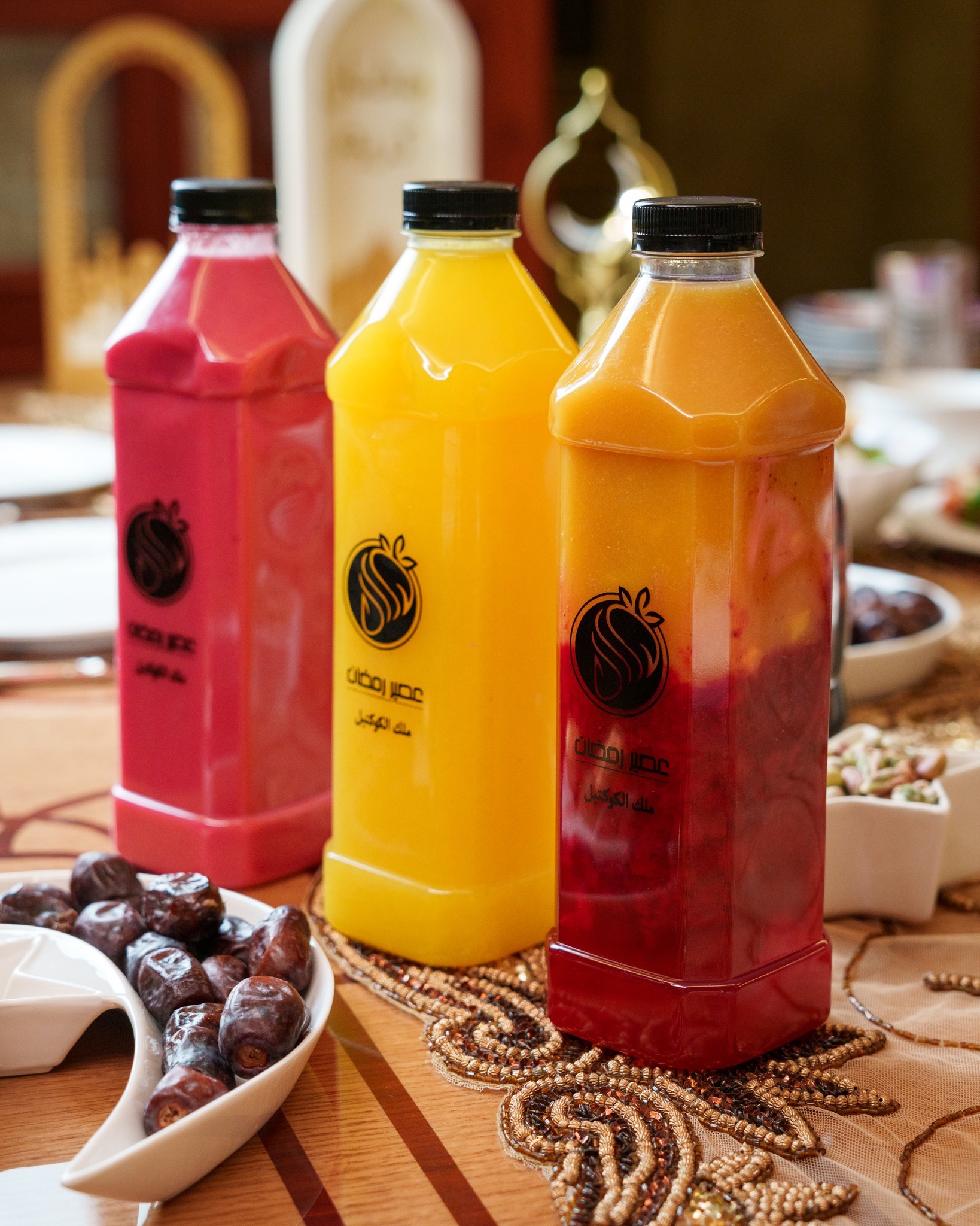 Three bottles of Ramadan Juice fresh juice standing on a table