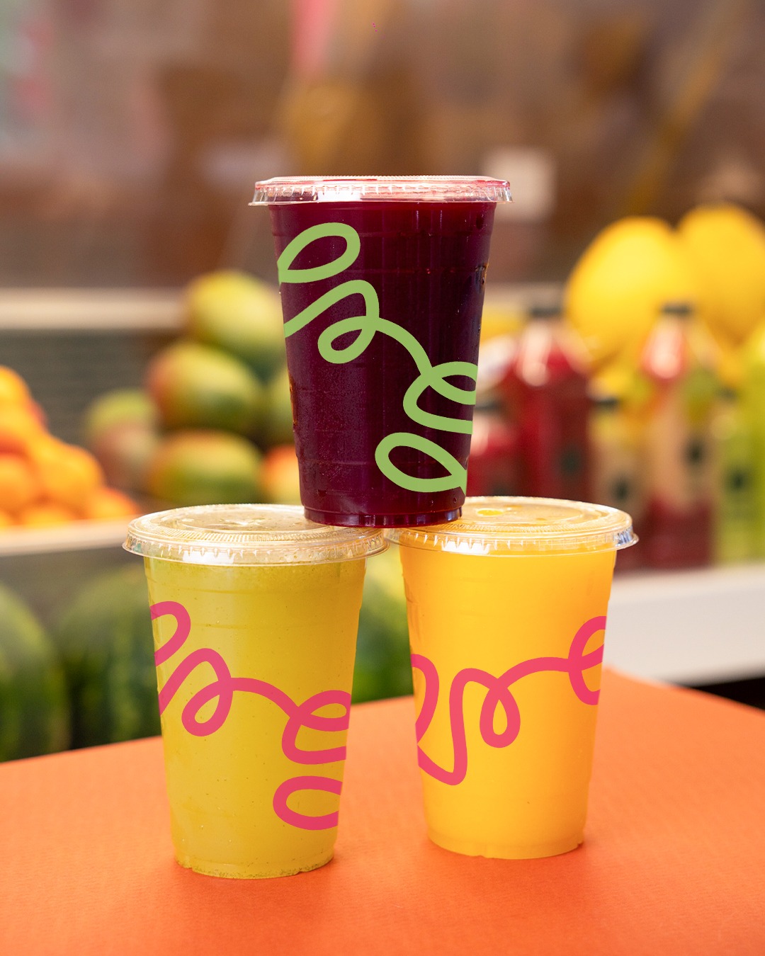 Ramadan Juice takeaway cups of orange and berry juice on the counter