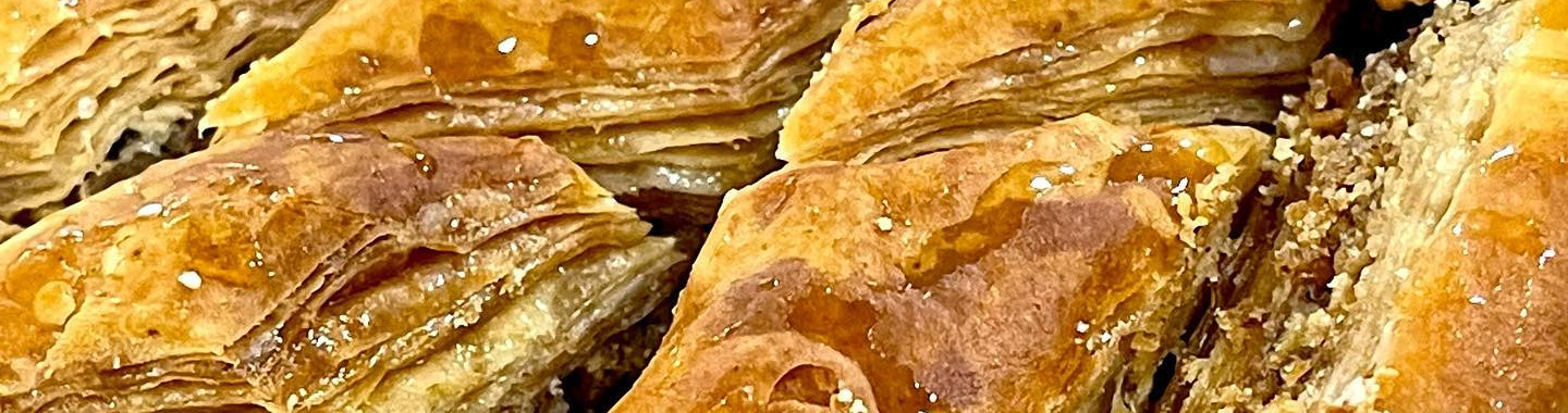 Baklawa fresh from the tray, layers of filo cut into diamonds and glazed with syrup