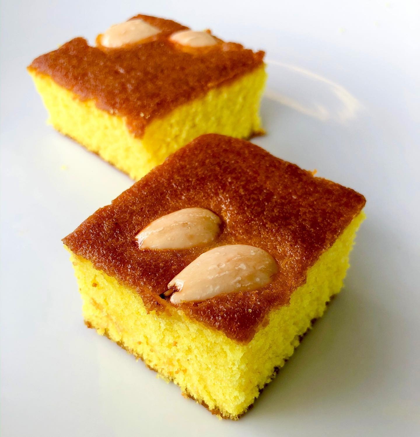 Squares of maamoul madd topped with whole almonds