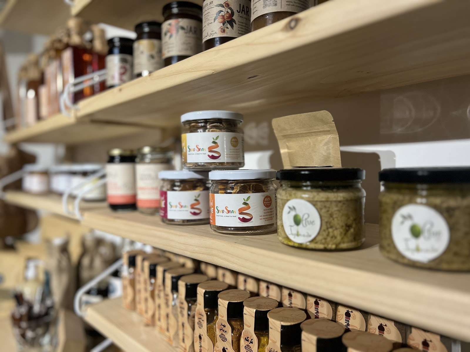Shelves of mooneh jars, infusions and spice blends