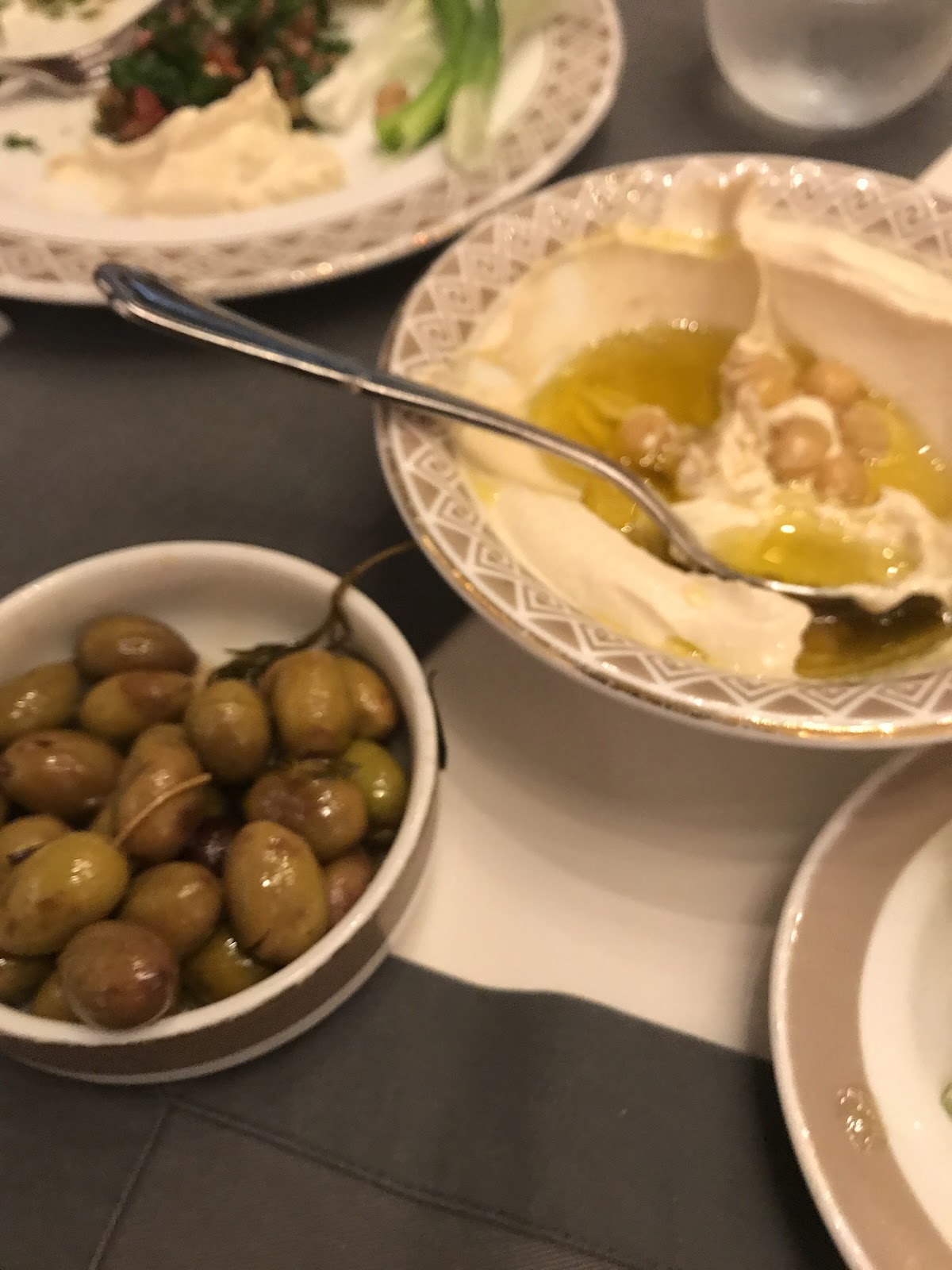 Olives, labneh and cold mezze bowls on the table