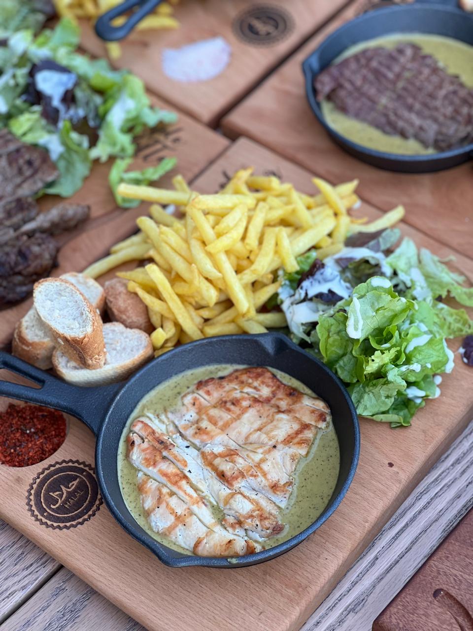 Chicken skillet platter with bread, fries and dips