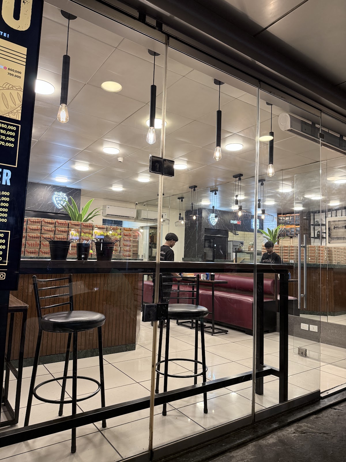 Inside the Mar Mikhael branch, counter stools and pendant lights