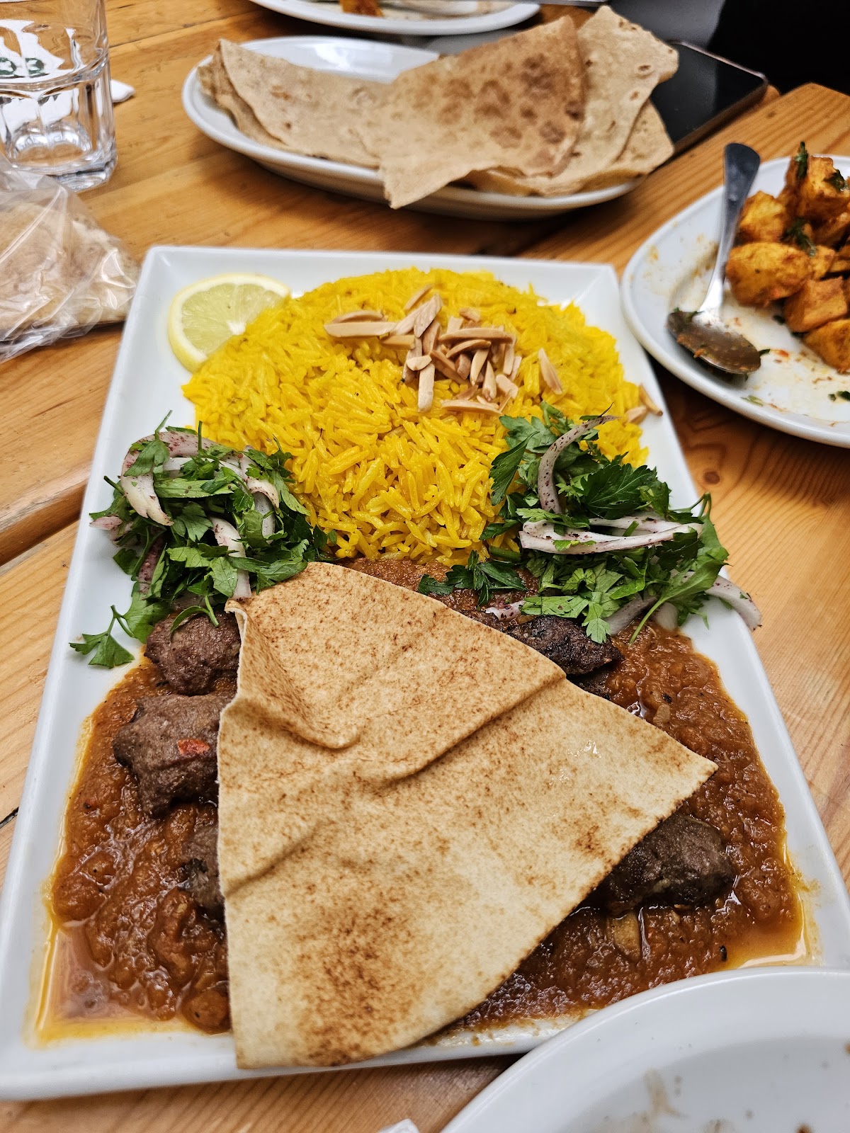 Kebab with saffron rice, bread and grilled tomato sauce
