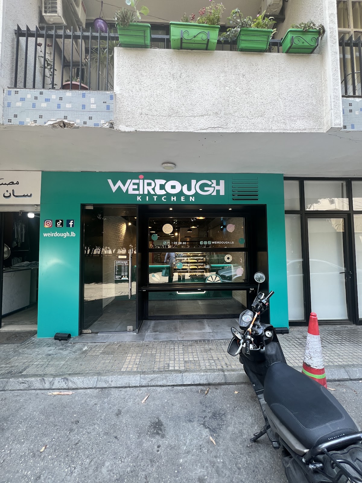 The Weirdough shopfront in teal on Madame Curie street