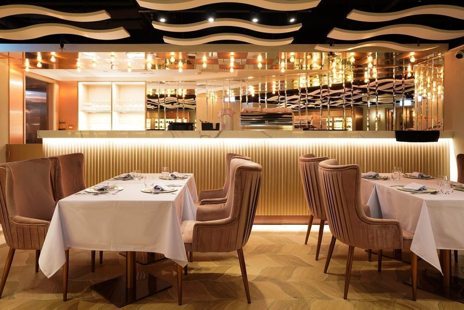 The A Lux dining room with its sculpted wave ceiling and mirrored bar