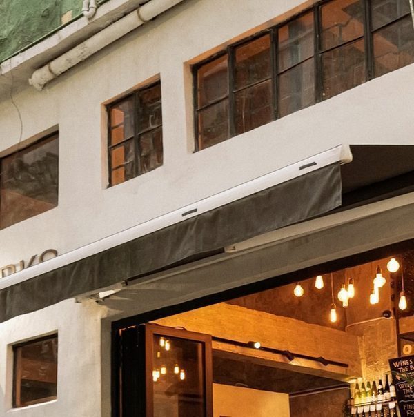 The CORKS shopfront on Hollywood Road, awning out and the doors folded open