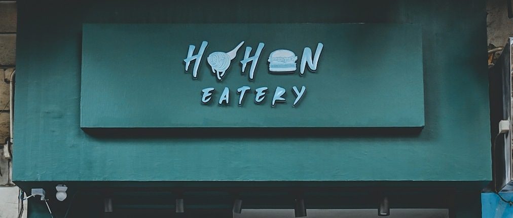 The teal painted fascia and HOHON EATERY sign on Queen's Road West